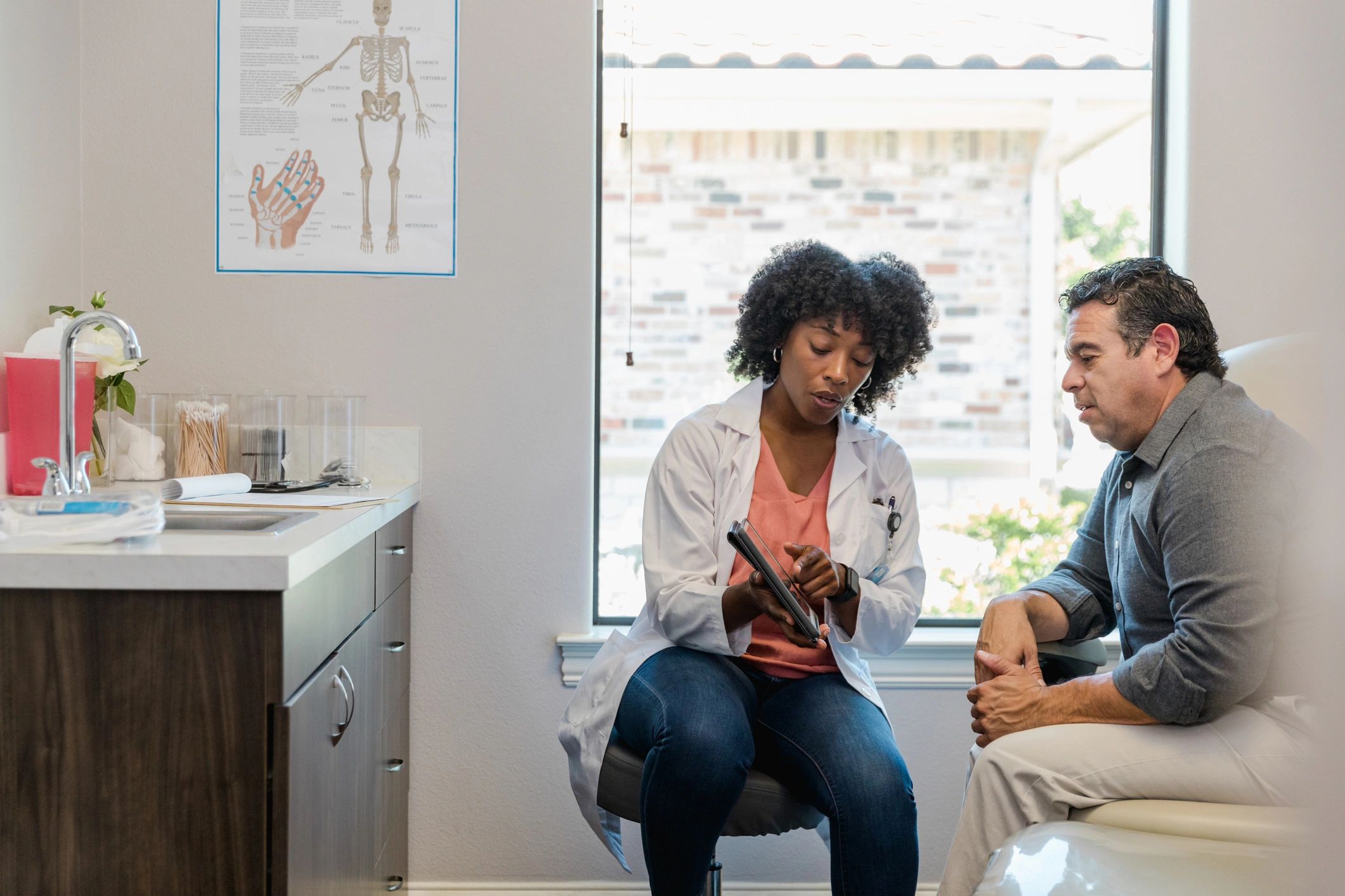 Doctor reviewing information with a patient during a primary care visit
