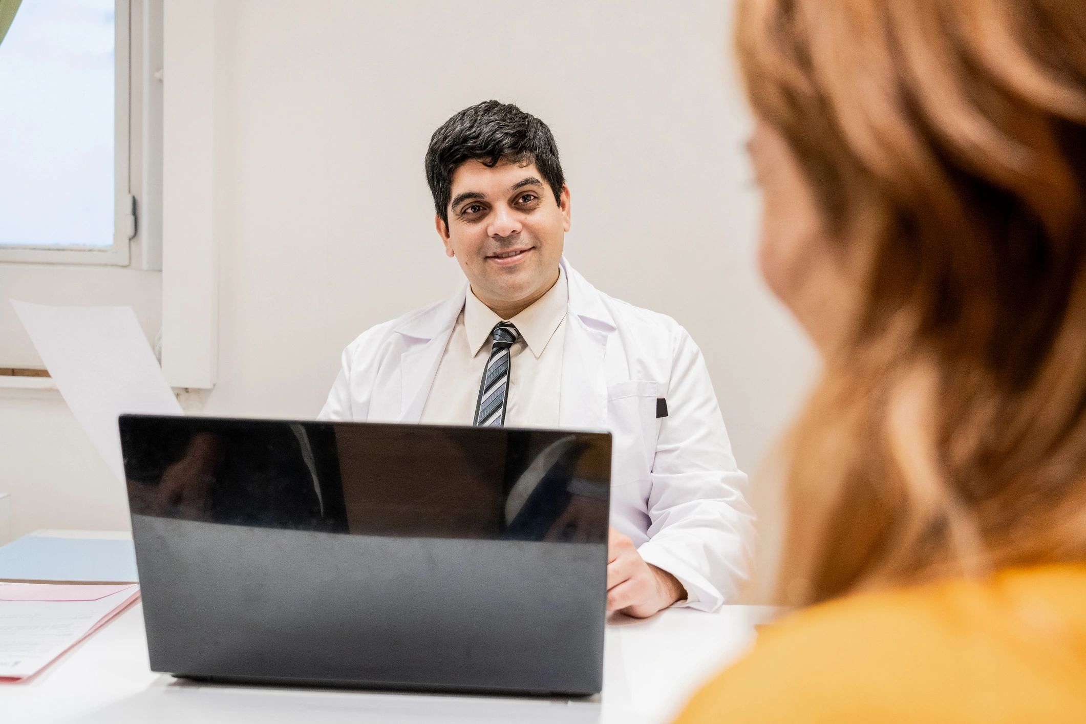 Doctor discussing care plan with a patient in an exam room